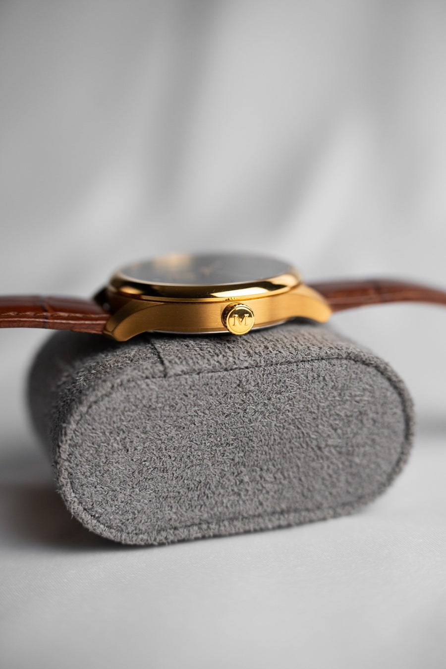 Side profile of the slim PVD gold case and signed crown